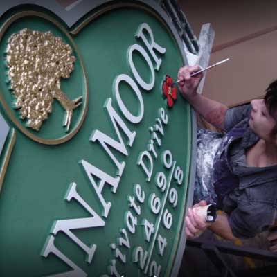 Inset green high density hdu sign with white lettering and gold logo hand painted by lady. Text reads: ...NAMOOR Private Drive