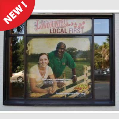 Vinyl picture of man and women leaning on a farm fence behind a glass business storefront