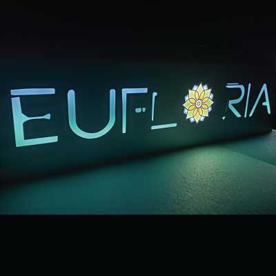 Glowing purple and blue slim-line indoor lighted sign. Text reads: Eufloria
