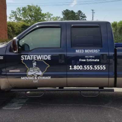 White logo and lettering on side of truck. Logo is a strong man on top of the outline of South Carolina. Text reads: STATEWIDE Moving and Storage LLC. Need Movers? Call for a free estimate