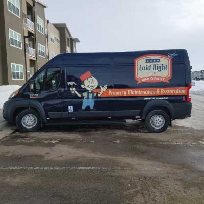 Orange with blank and white text and cartoon logo of handyman holding a hammer. Text reads: Laid Right LLC. High Quality. Property Maintenance & Restoration