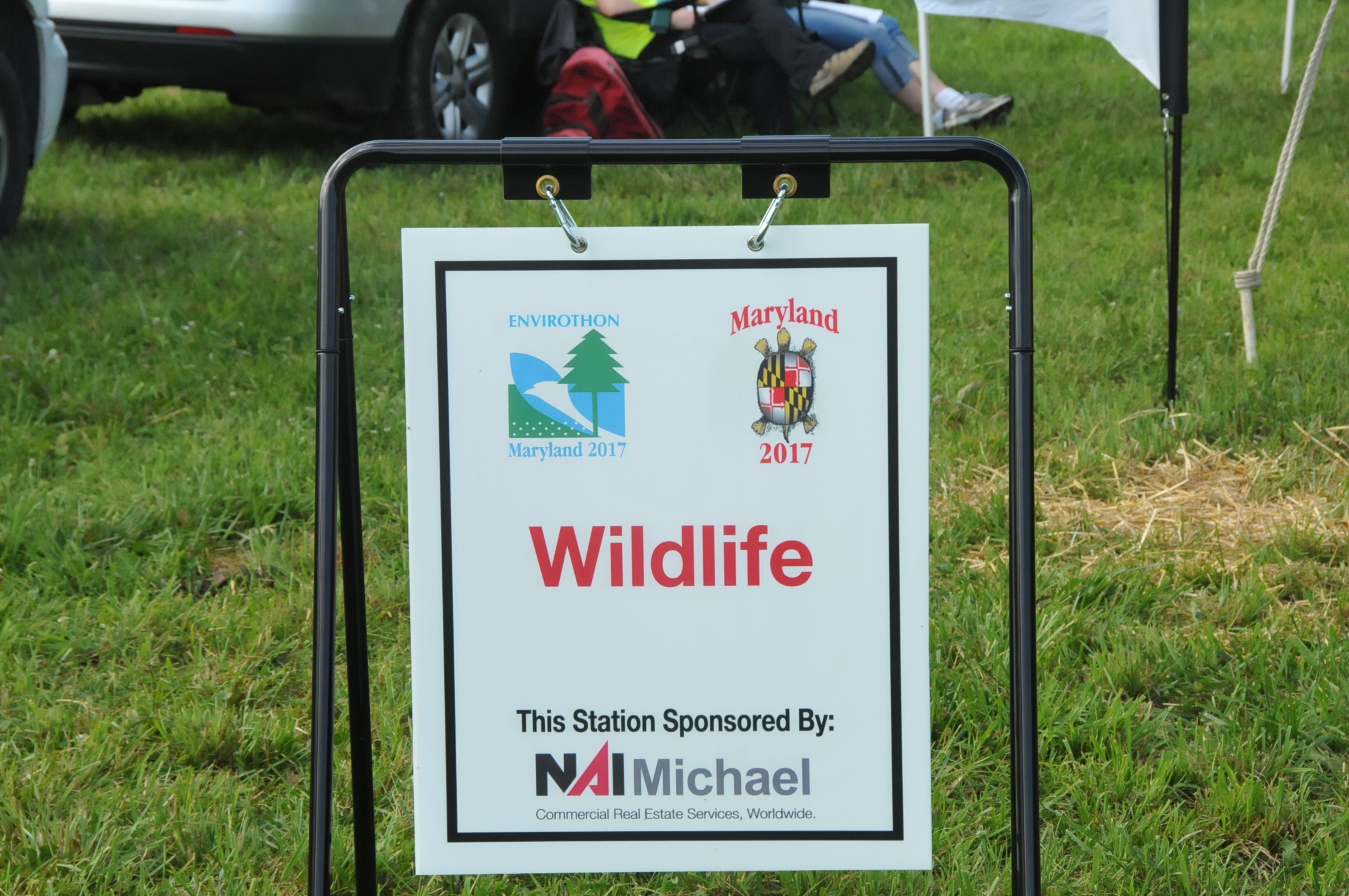 Metal Sidewalk Frame Displays sponsorship by real estate company