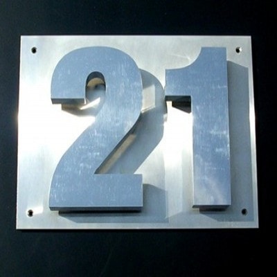 Brushed silver business sign in the shape of the number 21